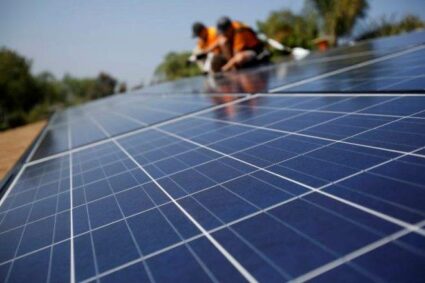 Solar Technicians Install Solar Panels On The Roof Of A Hous